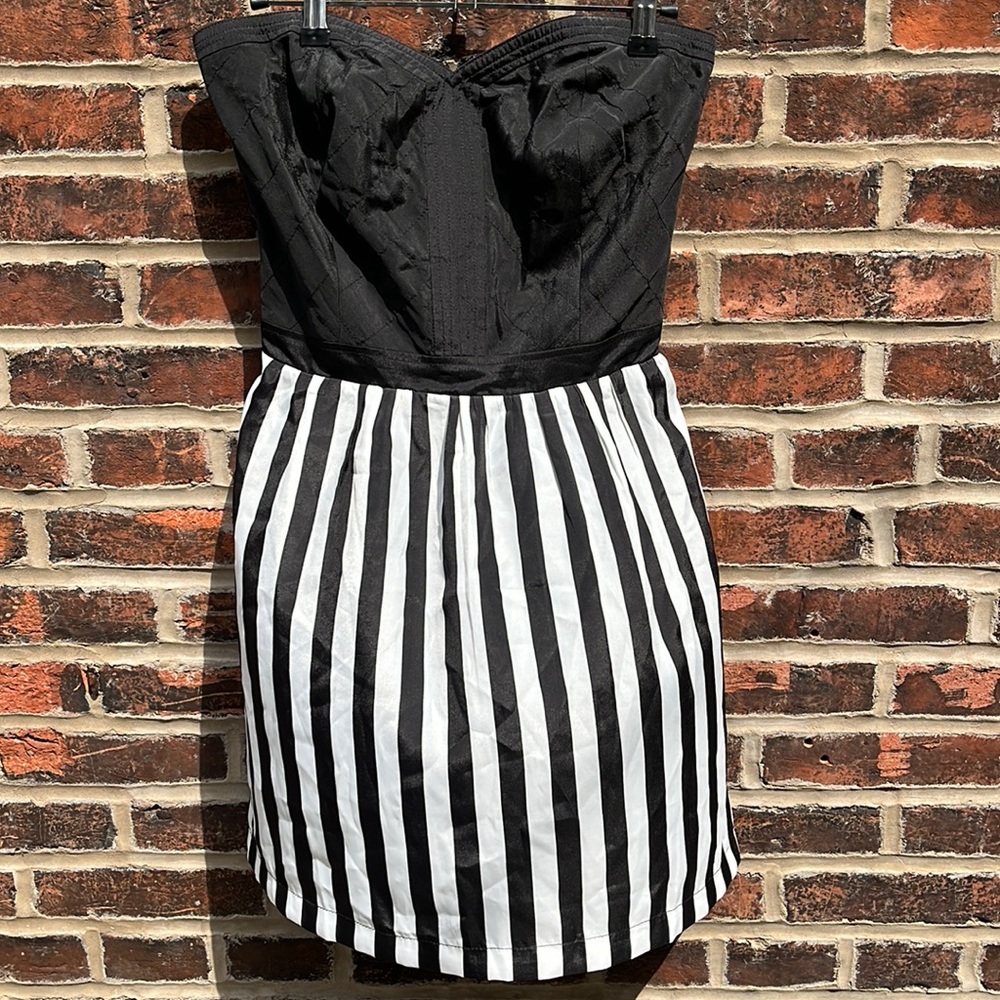 Black and white mini dress with sweetheart neckline and cross stitching on front